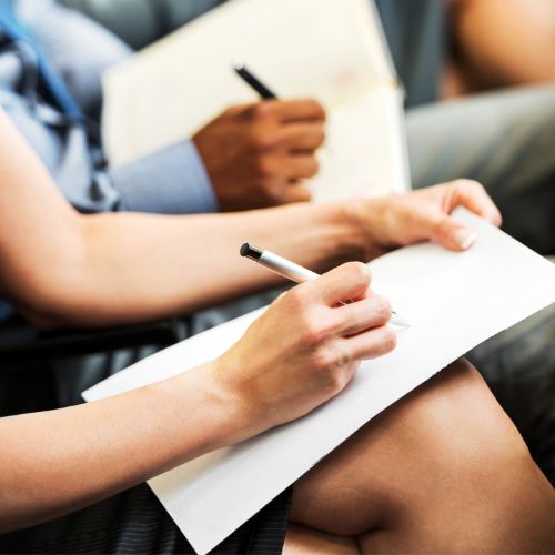 People taking notes during a workshop.